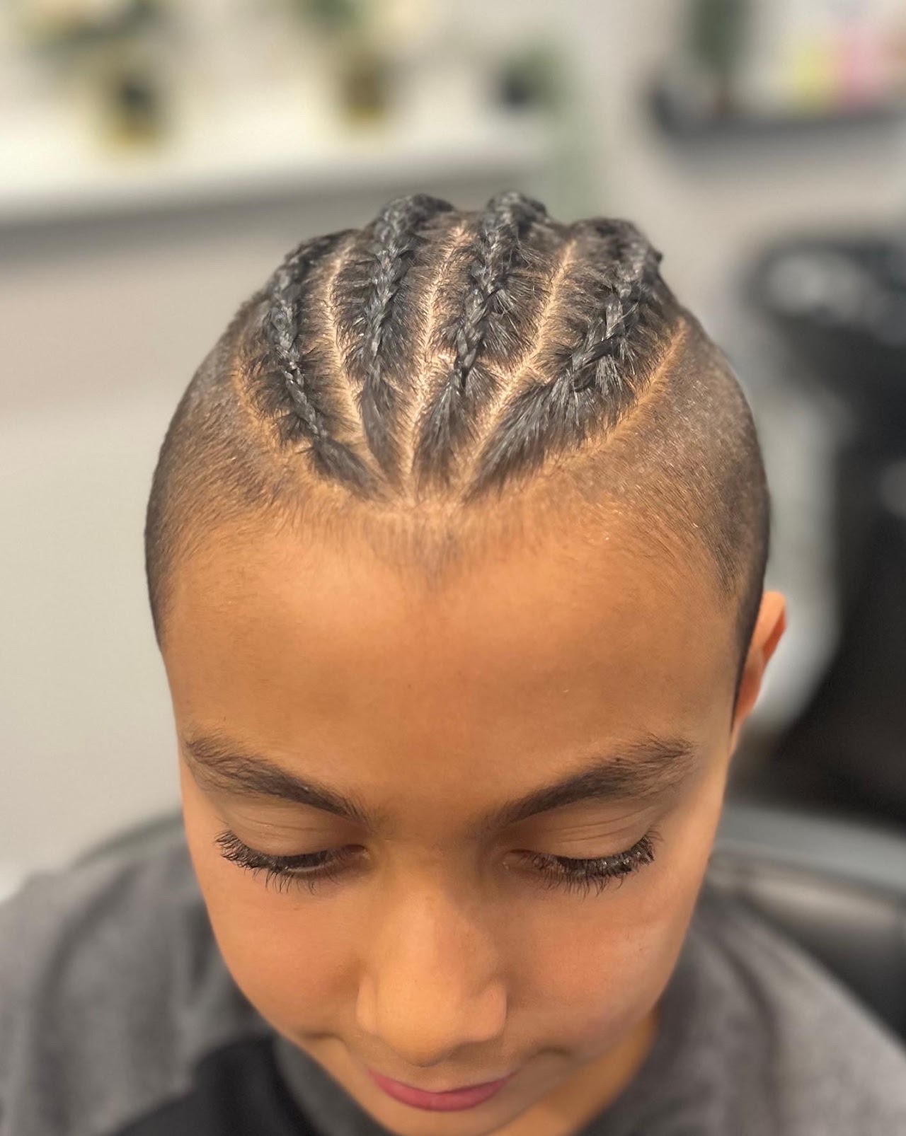 Neatly sectioned cornrow braids at HairSense